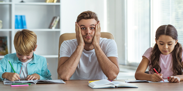 Father sitting with kids during homework